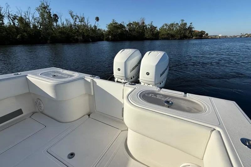 Slide: The Image of 2020 Sea Hunter 31 Tournament boat with twin Mercury engines on a calm lake. - 7