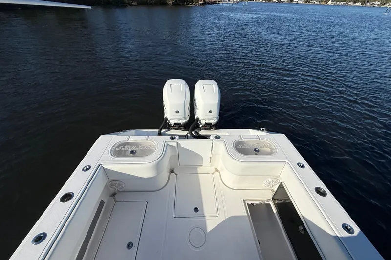 Slide: The Image of 2020 Sea Hunter 31 Tournament boat with dual engines on calm water. - 8