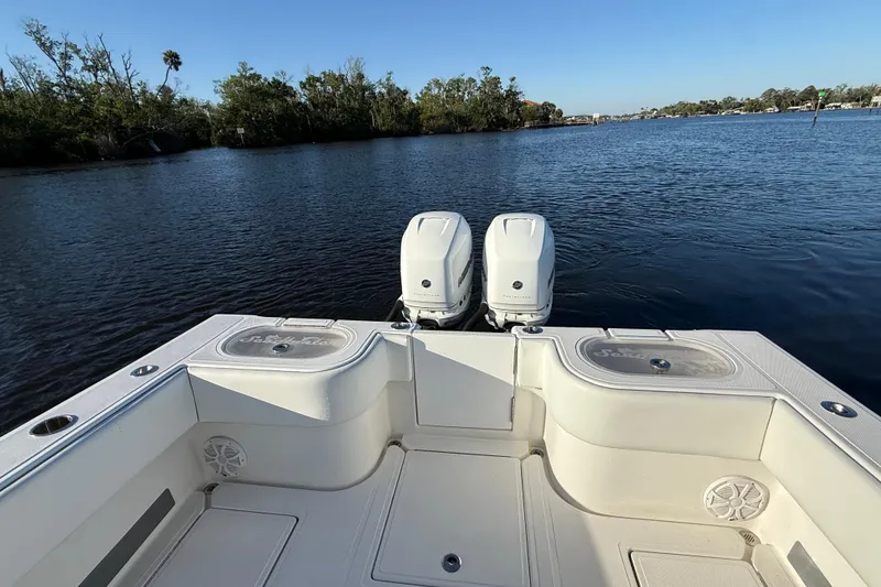 Slide: The Image of 2020 Sea Hunter 31 Tournament boat with dual engines on a calm river. - 9