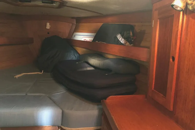 Slide: The Image of Cozy cabin interior of 1988 Freedom 36 sailboat with wooden furnishings and cushions. - 14