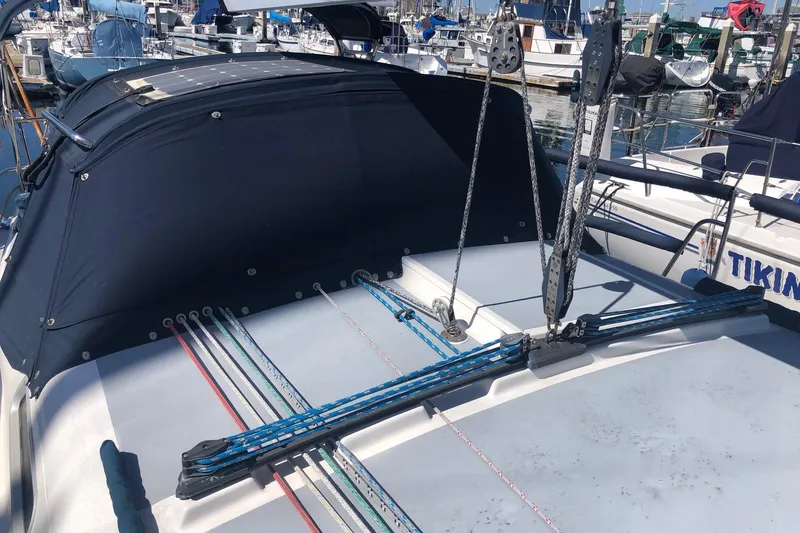 Slide: The Image of Sailboat deck of 1988 Freedom 36, featuring rigging and marina background. - 4