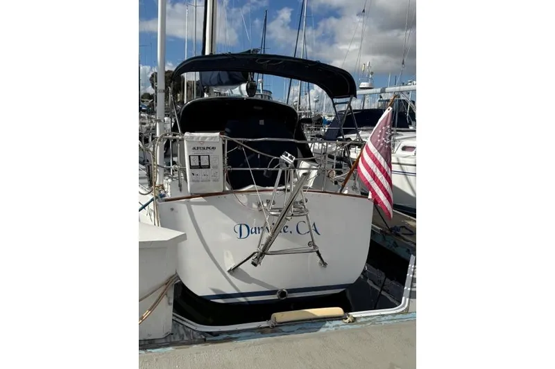 Slide: The Image of Sailboat docked at marina, Freedom 36 model, 1988, with American flag. - 6