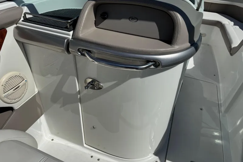 Slide: The Image of Interior of a 2005 Cobalt 240 boat, featuring a storage compartment and speaker. - 10