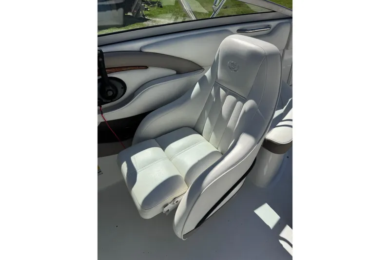 Slide: The Image of White leather seat in a 2005 Cobalt 240 boat, featuring elegant stitching. - 13