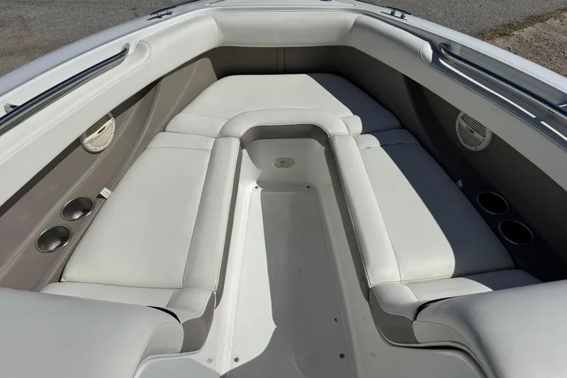 Slide: The Image of Interior seating of a 2005 Cobalt 240 boat, featuring white cushioned seats. - 18