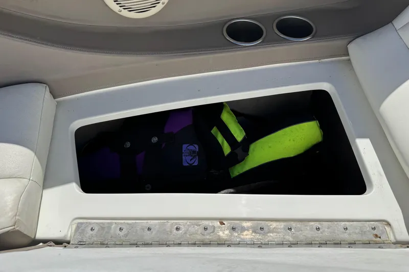 Slide: The Image of Storage compartment in a 2005 Cobalt 240 boat with life jackets inside. - 19