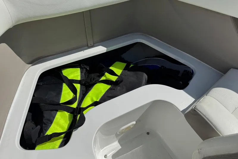 Slide: The Image of Storage compartment in a 2005 Cobalt 240 boat with life jackets inside. - 21