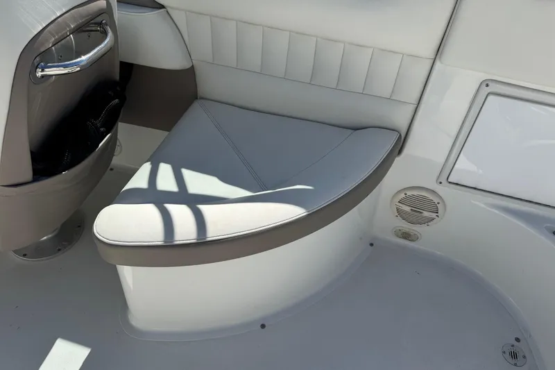 Slide: The Image of Interior seating of a 2005 Cobalt 240 boat, featuring white and gray upholstery. - 9
