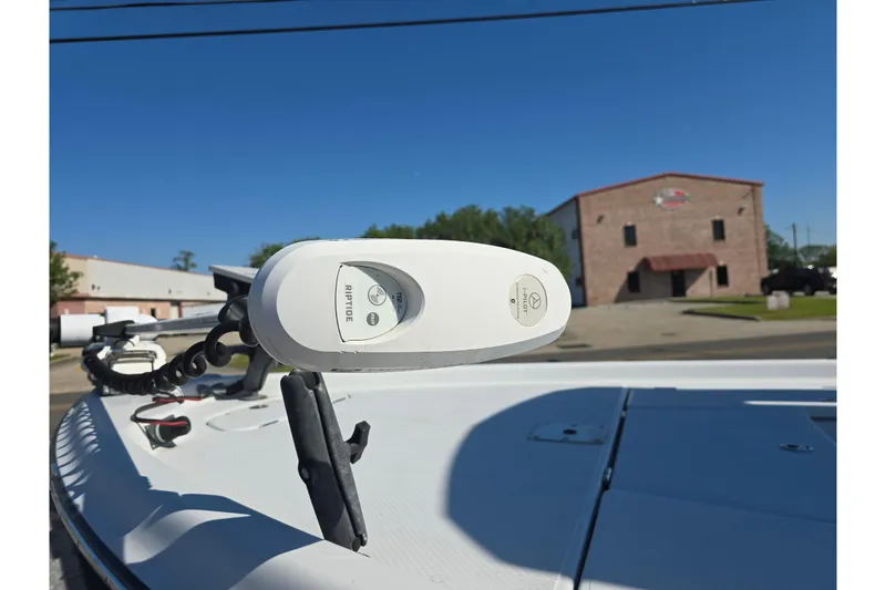 Slide: The Image of 2021 Blue Wave 2400 PureBay boat with Riptide trolling motor in a parking lot. - 11