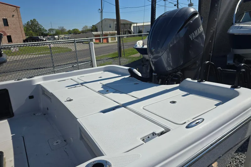 Slide: The Image of 2021 Blue Wave 2400 PureBay boat with Yamaha engine, docked outdoors. - 13