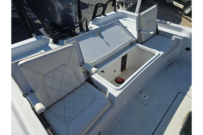 Slide: The Image of 2021 Blue Wave 2400 PureBay boat interior with open storage compartment and cushioned seats. - 16