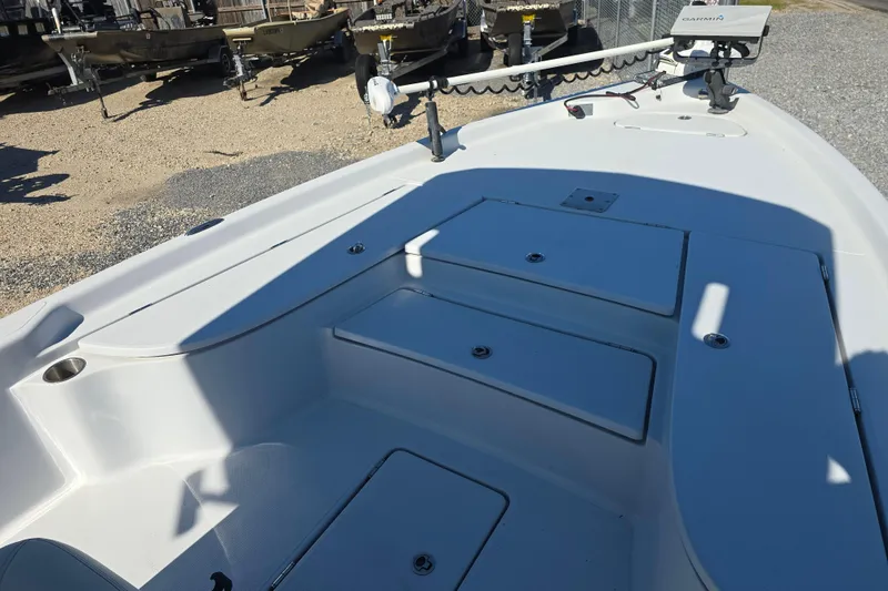 Slide: The Image of 2021 Blue Wave 2400 PureBay boat deck with storage compartments and trolling motor. - 17