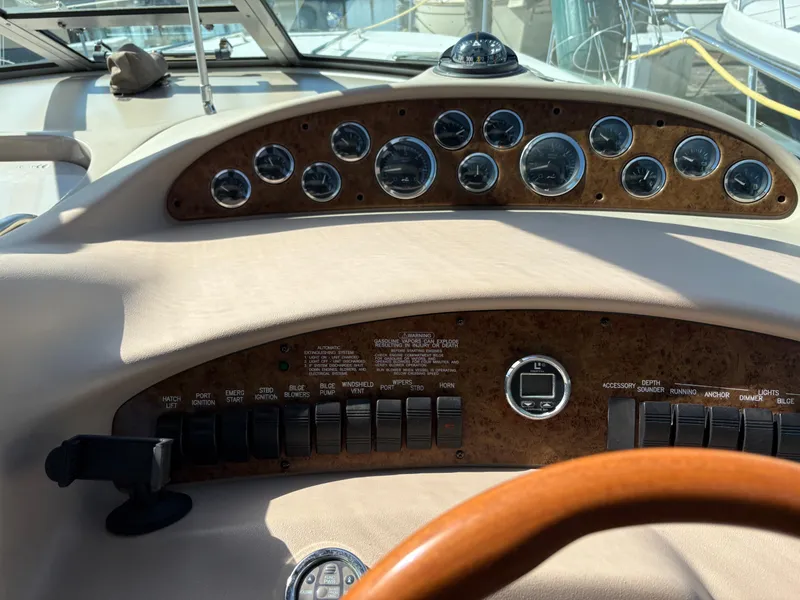 Slide: The Image of Dashboard of a 1999 Sea Ray 340 Sundancer boat with gauges and controls. - 15