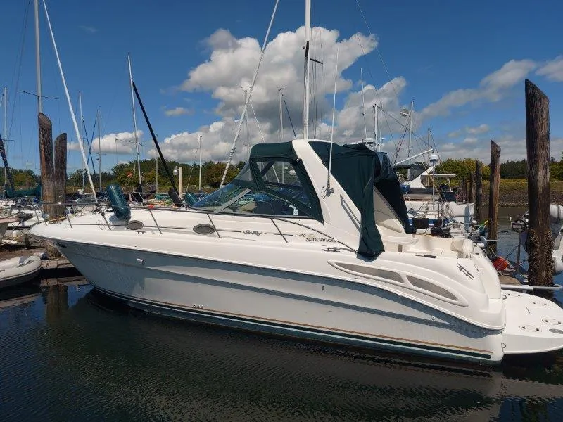 Slide: The Image of 1999 Sea Ray 340 Sundancer boat docked in a marina under a clear blue sky. - 19