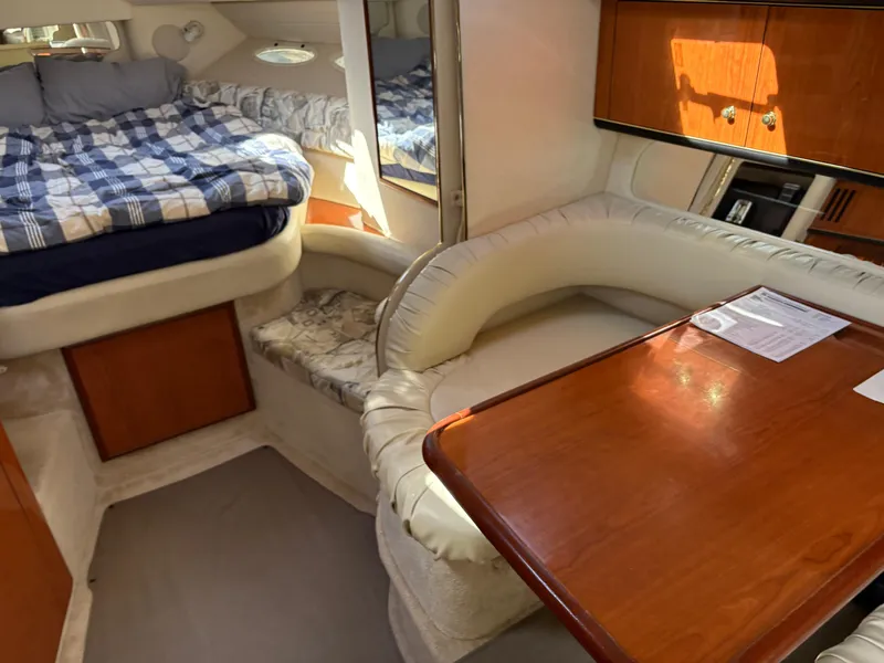 Slide: The Image of Interior of 1999 Sea Ray 340 Sundancer with cozy seating and sleeping area. - 23