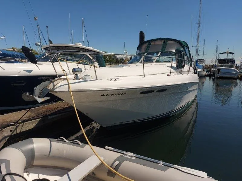 Slide: The Image of 1999 Sea Ray 340 Sundancer docked at marina, clear sky, calm water. - 3