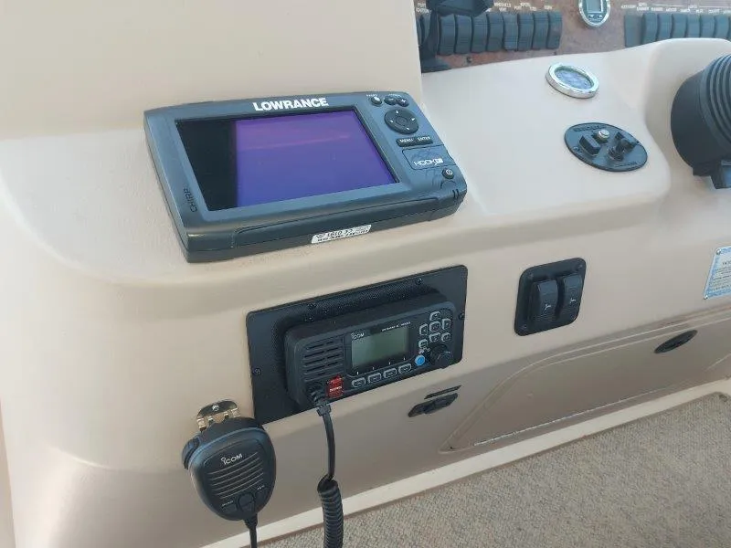 Slide: The Image of Control panel of a 1999 Sea Ray 340 Sundancer with navigation and communication equipment. - 33