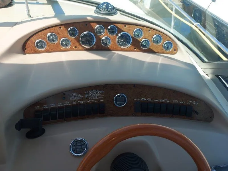 Slide: The Image of Dashboard of a 1999 Sea Ray 340 Sundancer boat with gauges and controls. - 36