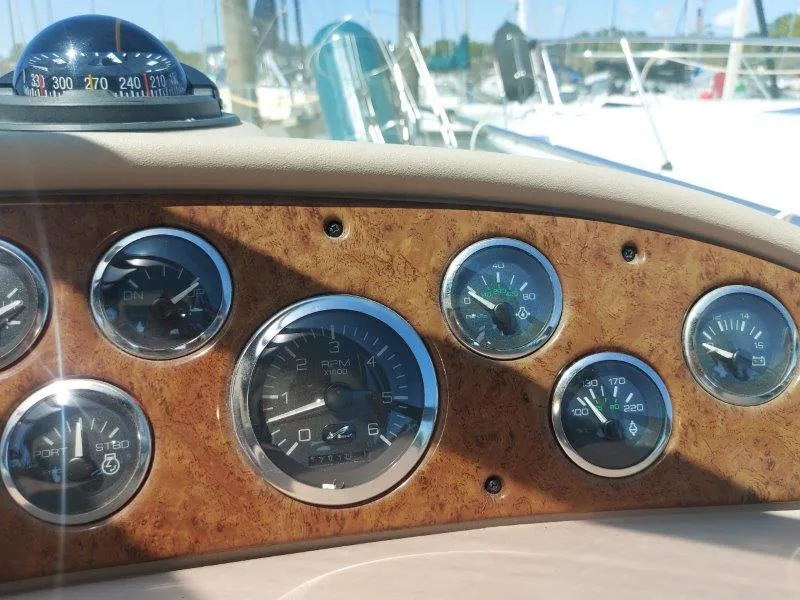 Slide: The Image of Dashboard of a 1999 Sea Ray 340 Sundancer boat with gauges and compass. - 37