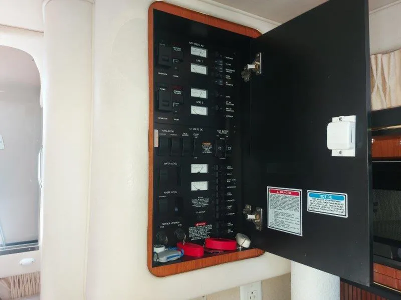 Slide: The Image of Electrical panel inside a 1999 Sea Ray 340 Sundancer boat, showing switches and labels. - 48