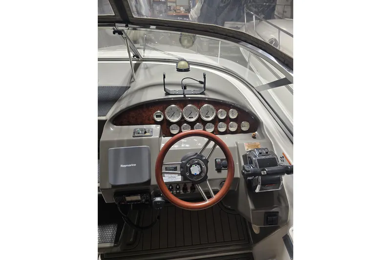 Slide: The Image of 2008 Regal 3060 Window Express boat dashboard with steering wheel and gauges. - 14