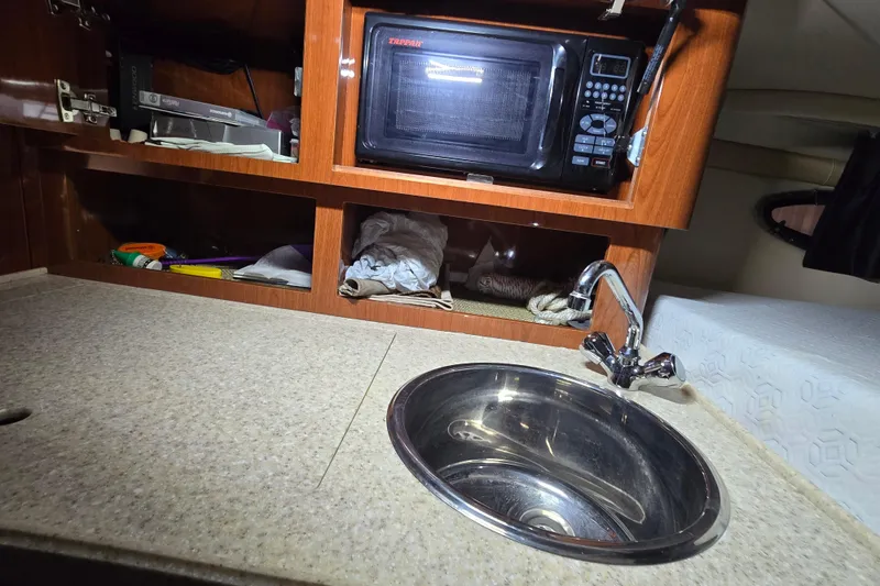 Slide: The Image of 2008 Regal 3060 Window Express boat interior with sink and microwave. - 23