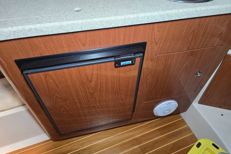 Slide: The Image of 2008 Regal 3060 Window Express interior with wood cabinetry and compact refrigerator. - 24