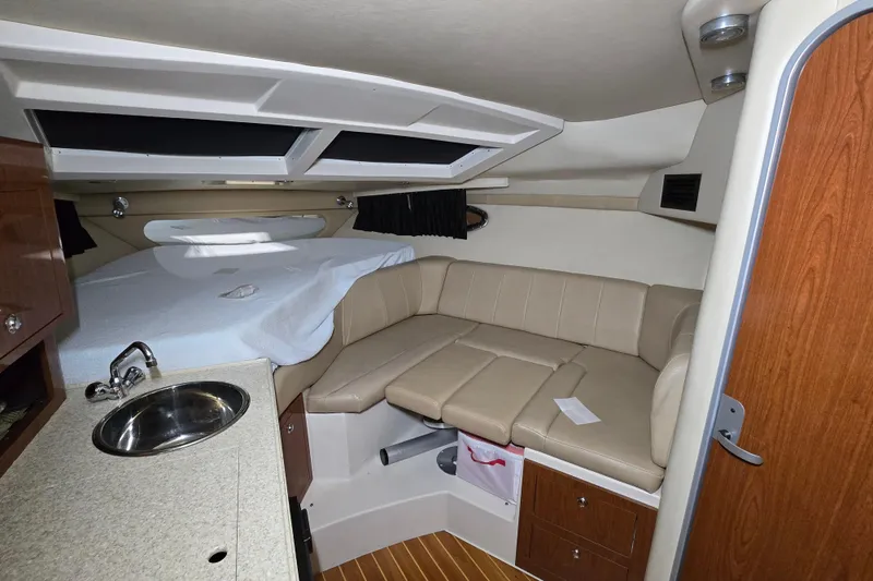 Slide: The Image of Interior of 2008 Regal 3060 Window Express boat with kitchenette and seating area. - 26