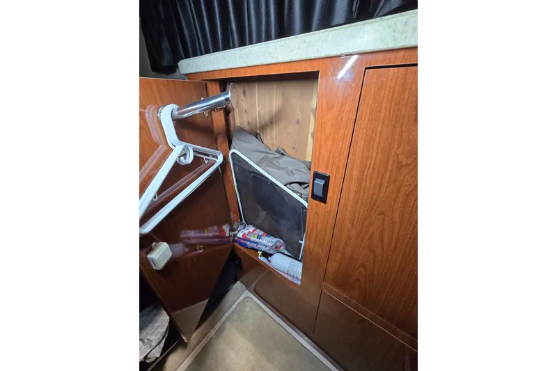 Slide: The Image of 2008 Regal 3060 Window Express cabin closet with hangers and storage items. - 27