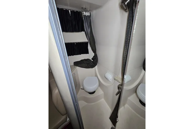 Slide: The Image of Compact bathroom in 2008 Regal 3060 Window Express boat, featuring toilet and shower. - 28