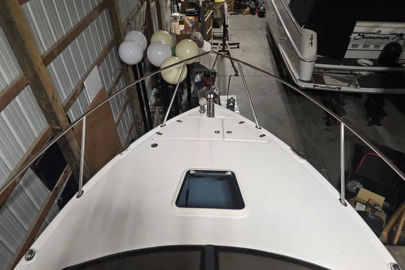 Slide: The Image of 2008 Regal 3060 Window Express boat in storage, viewed from above, with balloons nearby. - 4