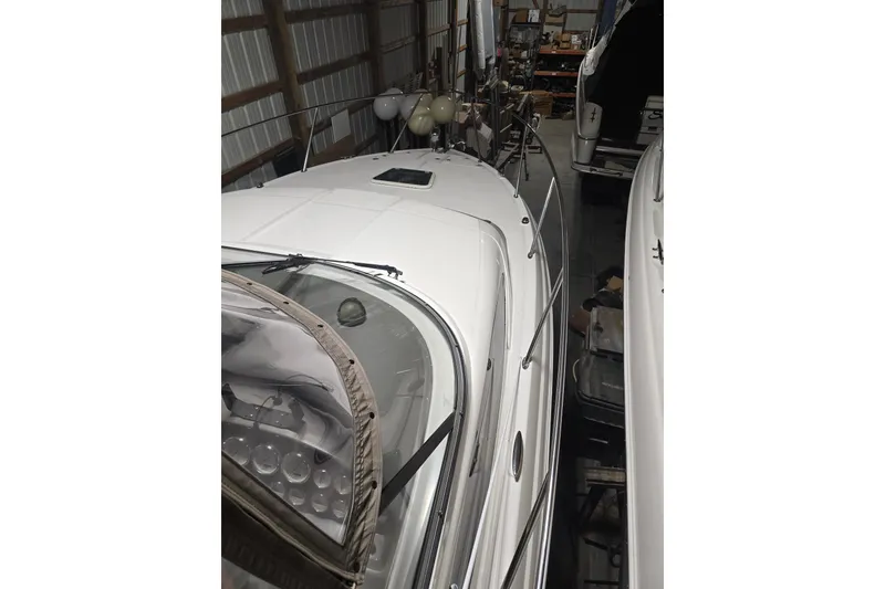 Slide: The Image of 2008 Regal 3060 Window Express boat in storage, showcasing sleek design and white exterior. - 5