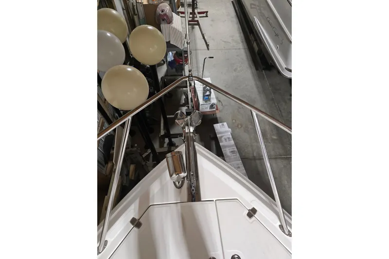 Slide: The Image of 2008 Regal 3060 Window Express boat bow with railings in storage. - 6