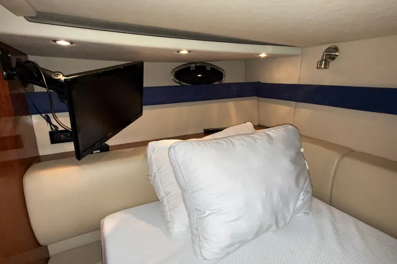 Slide: The Image of Interior cabin of 2004 Cruisers Yachts 340 Express with bed and mounted TV. - 10