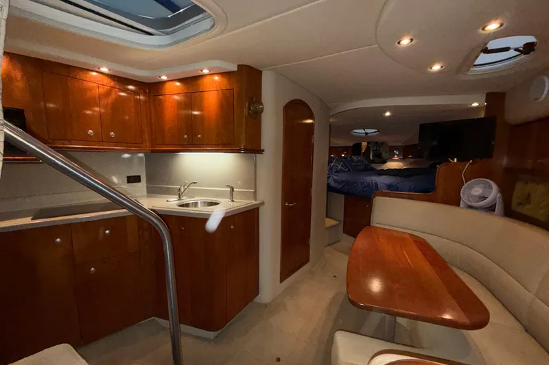 Slide: The Image of Luxurious interior of 2004 Cruisers Yachts 340 Express with wood cabinetry and cozy seating. - 11