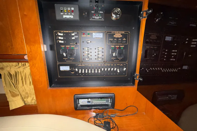 Slide: The Image of Electrical control panel inside 2004 Cruisers Yachts 340 Express, featuring various switches and gauges. - 14
