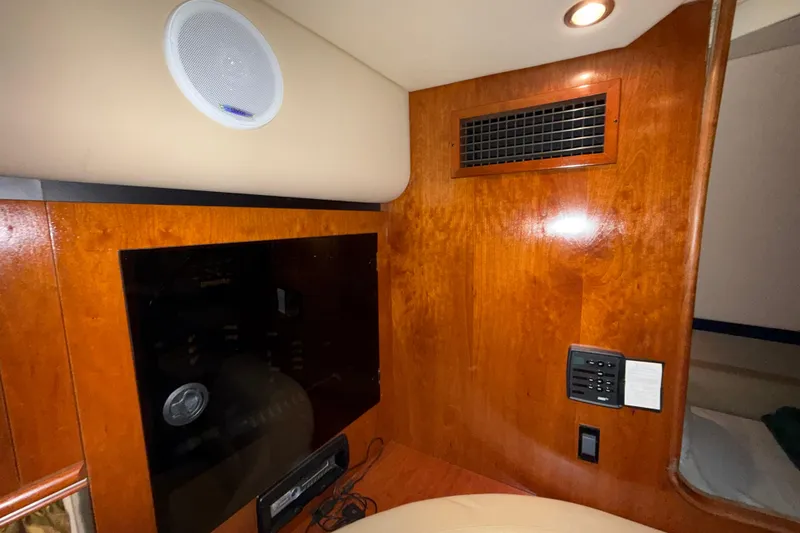 Slide: The Image of Interior of 2004 Cruisers Yachts 340 Express with wood paneling and speaker system. - 15