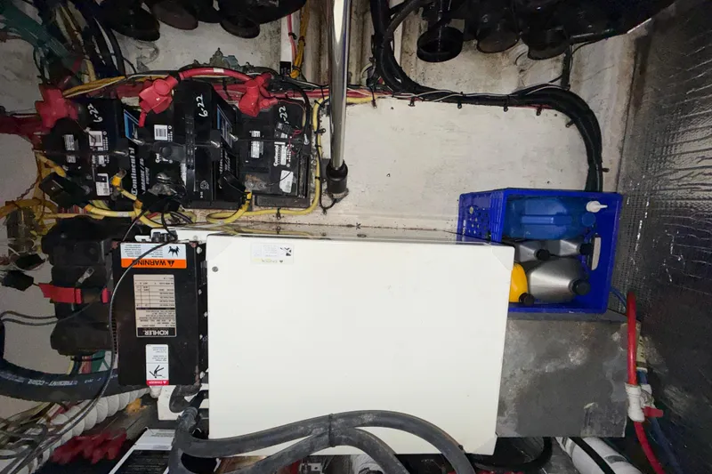 Slide: The Image of Engine compartment of a 2004 Cruisers Yachts 340 Express, featuring batteries and wiring. - 20