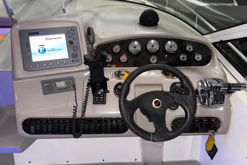 Slide: The Image of 2004 Cruisers Yachts 340 Express dashboard with navigation display and controls. - 24