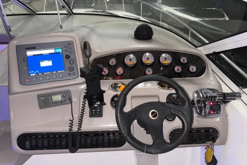 Slide: The Image of Helm of 2004 Cruisers Yachts 340 Express with gauges and navigation equipment. - 28