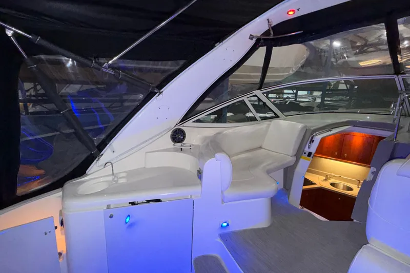 Slide: The Image of 2004 Cruisers Yachts 340 Express interior with seating and kitchenette. - 35