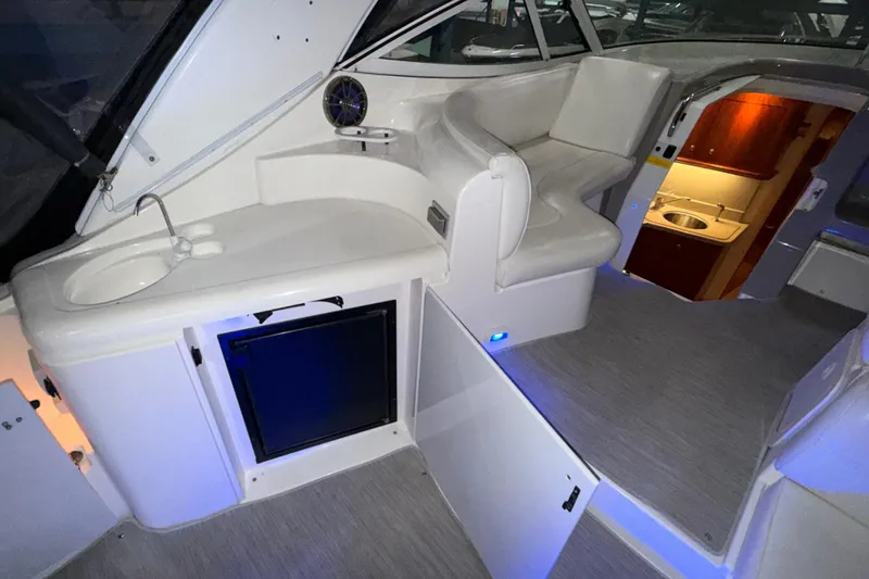 Slide: The Image of 2004 Cruisers Yachts 340 Express interior with seating, sink, and cabin entrance. - 37