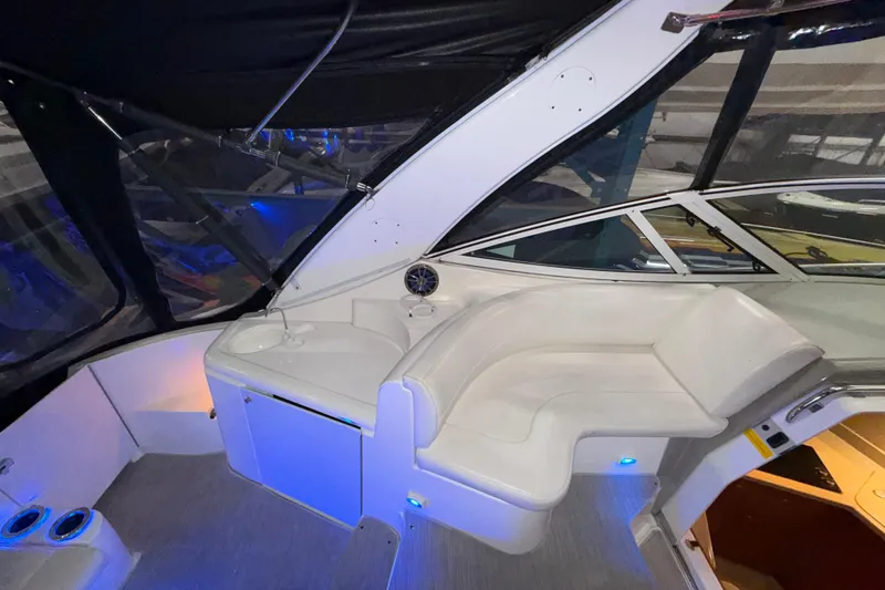 Slide: The Image of 2004 Cruisers Yachts 340 Express interior with white seating and ambient lighting. - 39