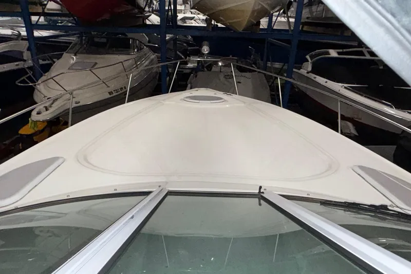 Slide: The Image of 2004 Cruisers Yachts 340 Express in storage, surrounded by other boats. - 40