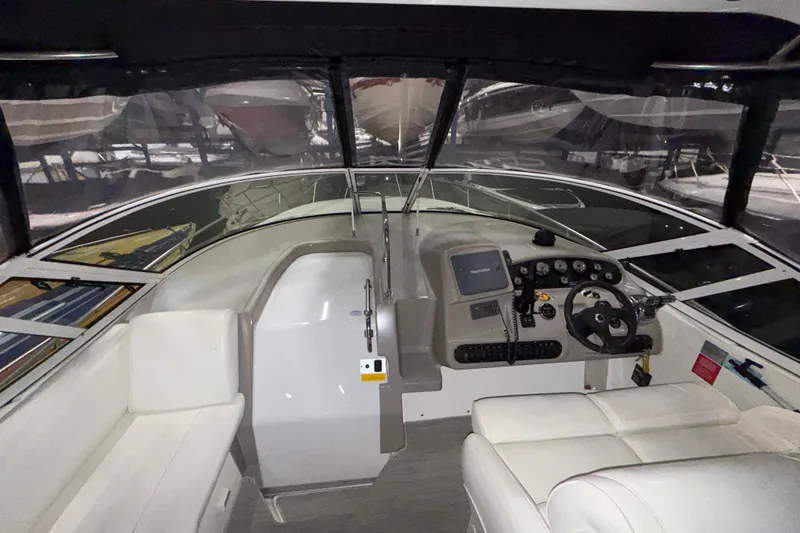 Slide: The Image of 2004 Cruisers Yachts 340 Express cockpit with steering wheel and navigation controls. - 41