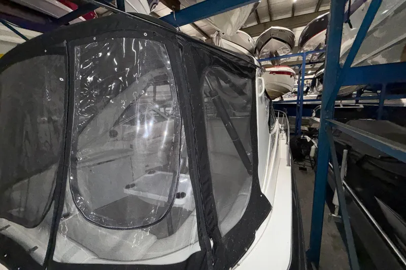 Slide: The Image of 2004 Cruisers Yachts 340 Express in storage with protective cover. - 43