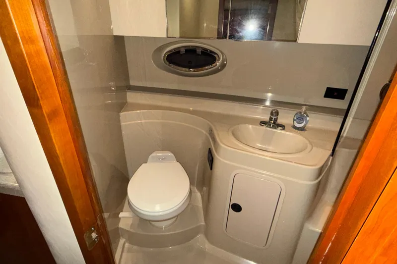 Slide: The Image of 2004 Cruisers Yachts 340 Express bathroom with toilet, sink, and mirror. - 5