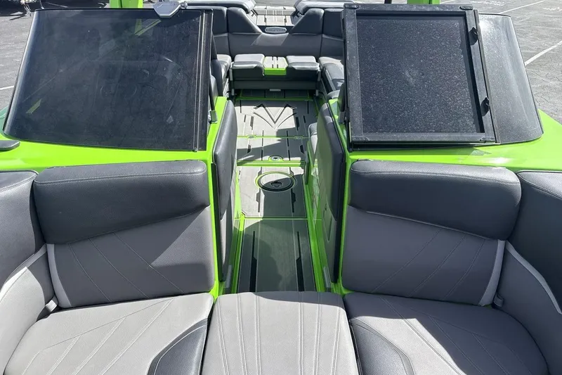 Slide: The Image of 2022 Supra SA 450 boat interior with gray seating and green accents. - 12
