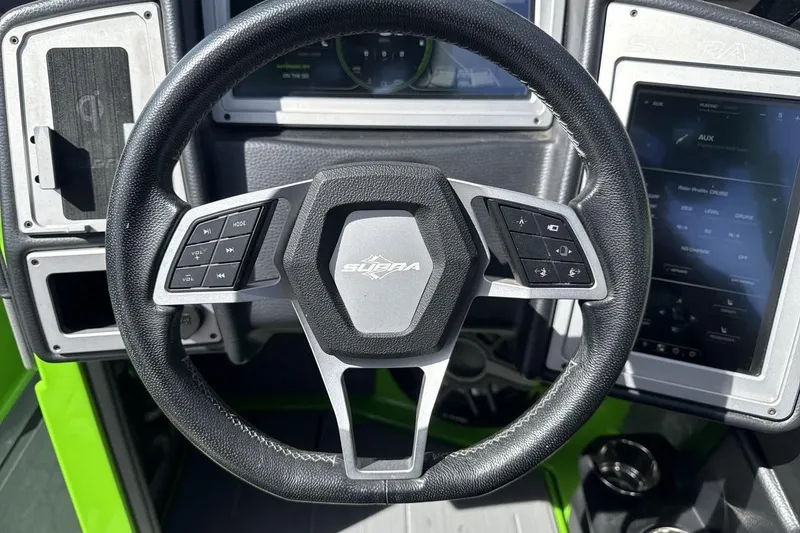 Slide: The Image of Steering wheel of 2022 Supra SA 450 with control buttons and dashboard display. - 14