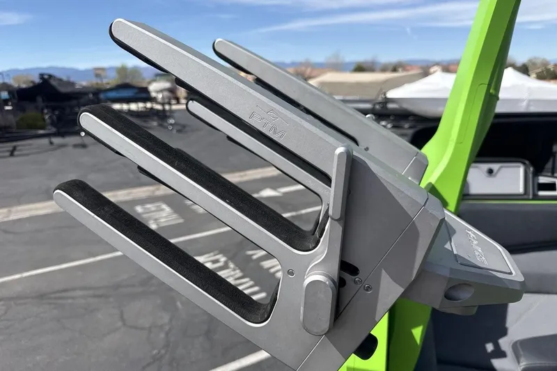 Slide: The Image of Close-up of 2022 Supra SA 450 boat accessory with green accents in a parking lot. - 22